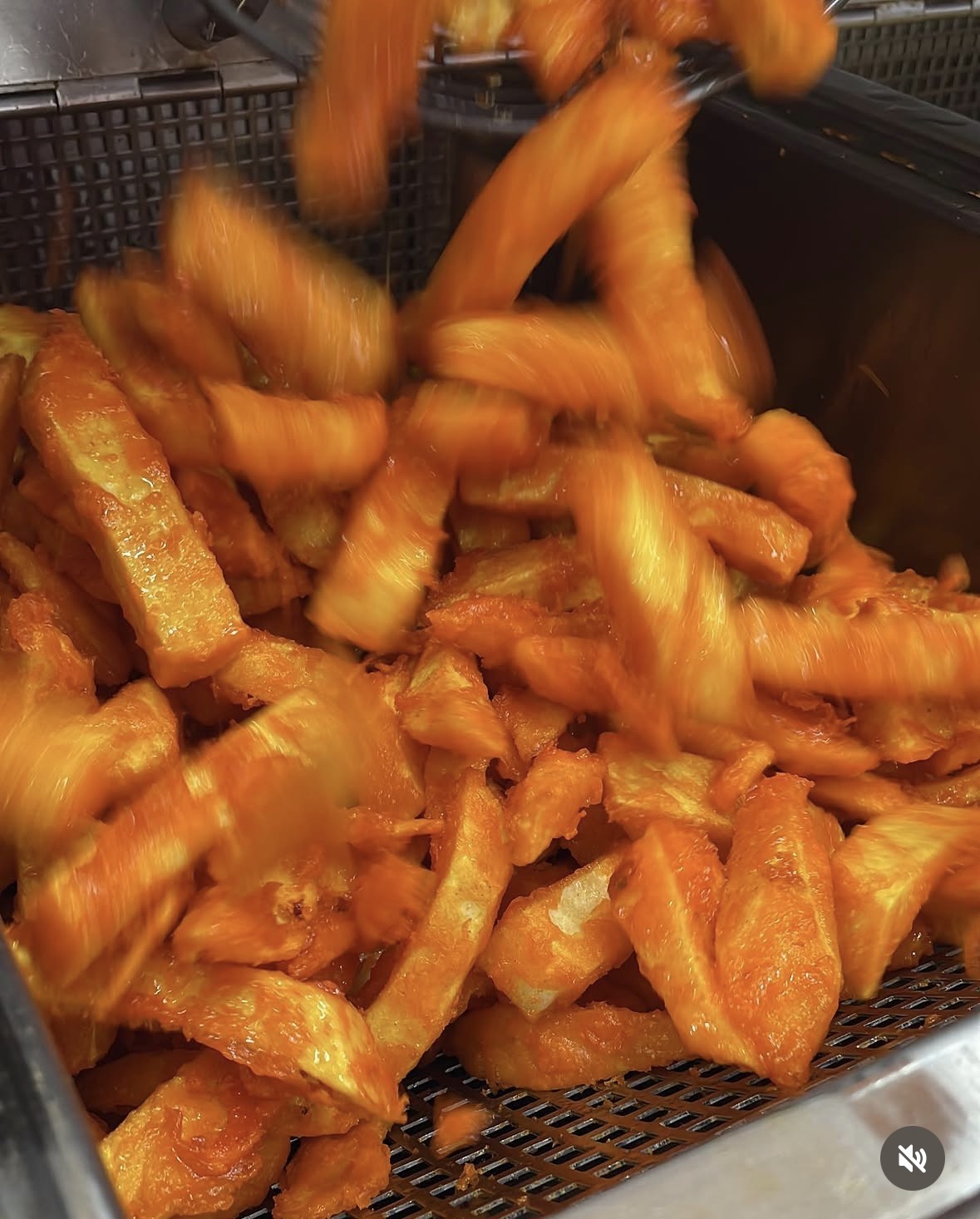 Fresh golden battered chips tumbling into the Trident chip counter